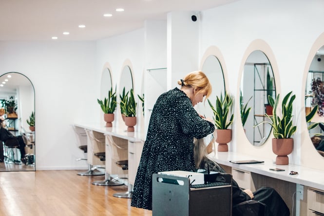 Hairdresser working on lady's hair at Chere Chérie in Christchurch.