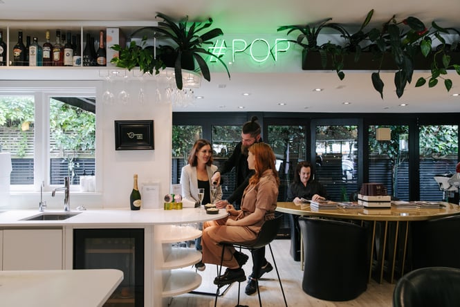 Two woman having a glass of champagne at Mod's Hair, Christchurch.