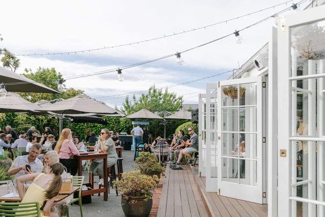 Groups of diners sitting in outside courtyard of Dux Dine in Christchurch