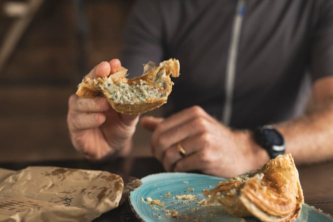 Customer eating a paua pie.