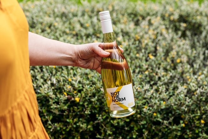 A customer holds a bottle of wine at Ōhau Wines.