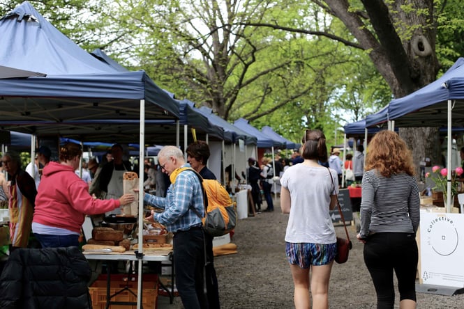 People strolling through Christchurch Farmer's Market on a cold day.