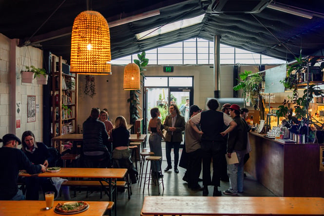 People hanging out inside a dimly lit restaurant.