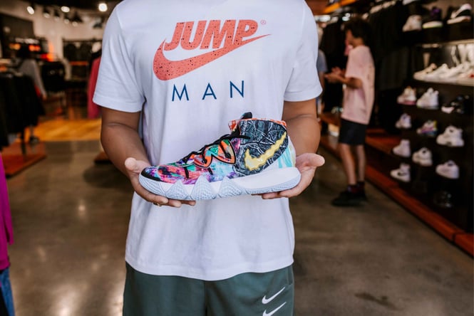 A man holding a sneaker at Nike in Britomart.