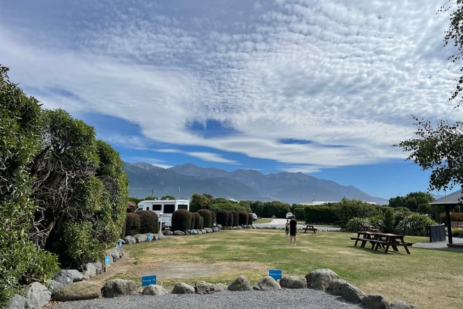 Kids playing on a grassy lawn in a campground.