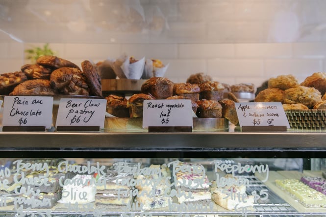 Pastries, roast vegetable loaf and scone sitting on top of cabinet at Lux in Christchurch
