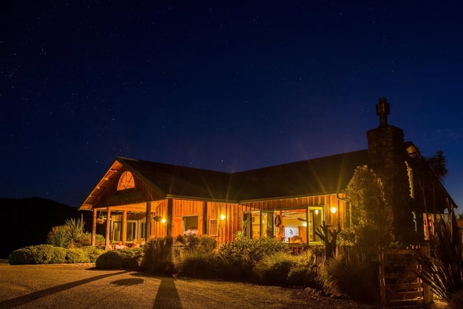 Makoura Lodge building lit up at night.