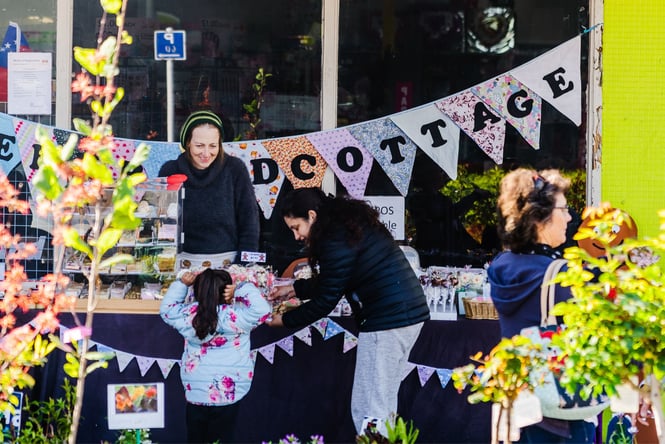 Customers and stallholders chatting.