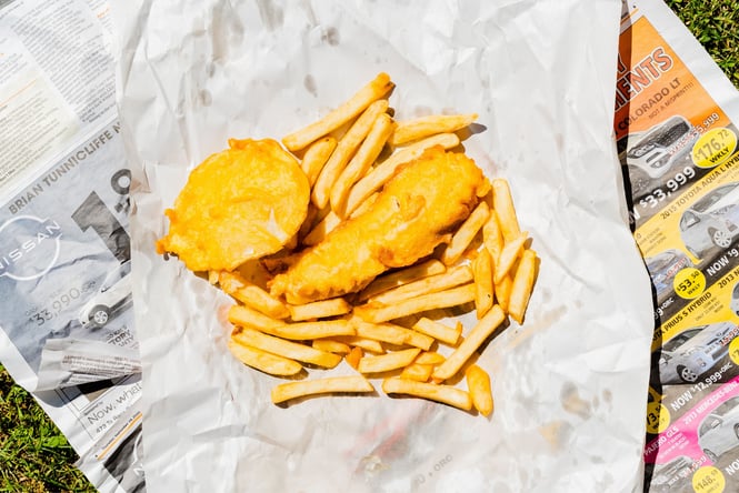 Fish and chips on the grass.