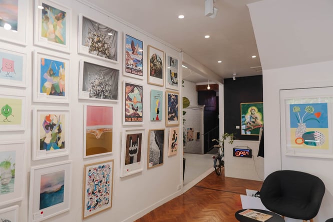 Wall with lots of hanging art from Endemic World.