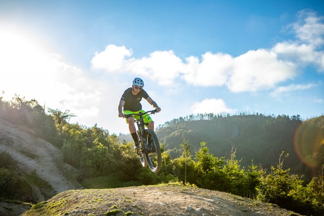 Mountain bike rider in the middle of a jump at Arapuke.