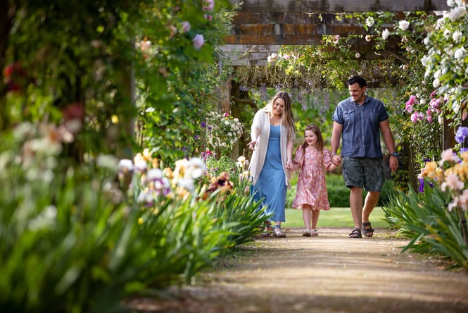 Family walking through gardens.