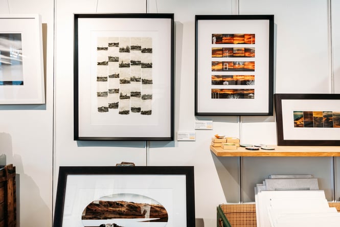 Framed works of art on a wall.