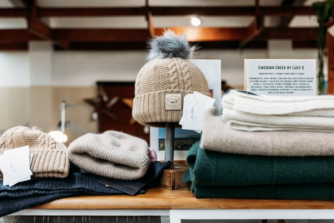 Hats and scarves on display in a retail store.