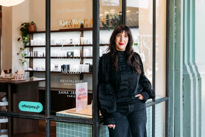 A woman wearing all black looking at the camera.