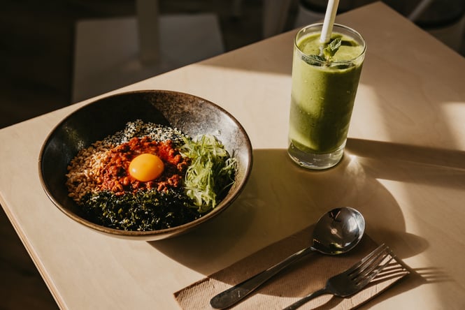 Bowl of Maze Udon next to iced matcha on table at PocaPoca in Cashmere Christchurch