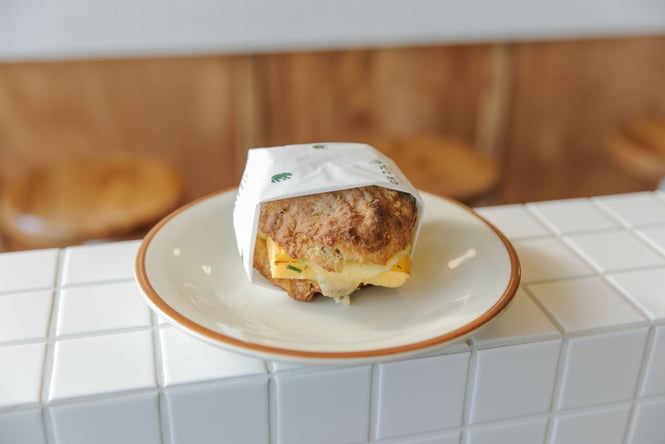 Close up of buttermilk biscuit sitting on tiled ledge at Grizzly Cashel St