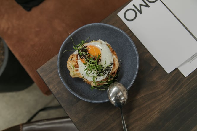Flat lay of breakfast dish with a fried egg on top at Kokomo in Christchurch