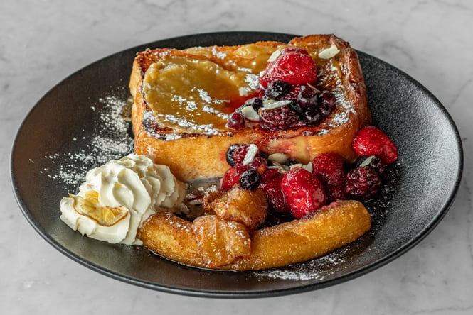 Plate of Kaya-inspired French Toast with berries on top
