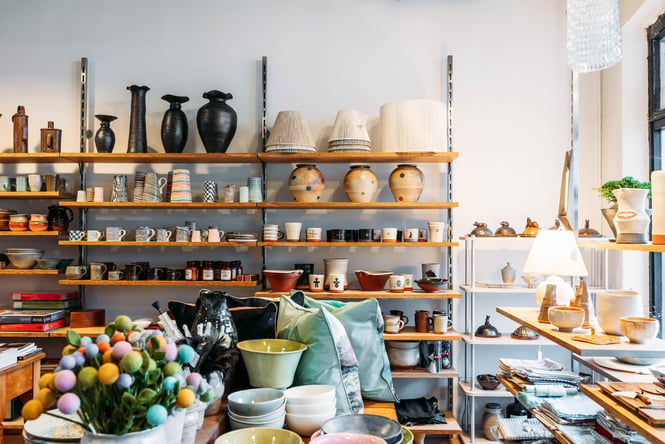Ceramics, dining ware and other items are arranged on shelves and table displays at Vessel.