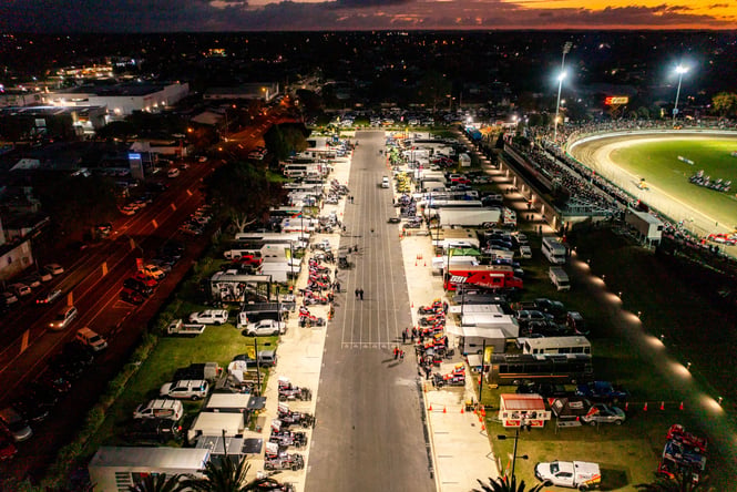 Cars lined up in the pits at the Speedway.