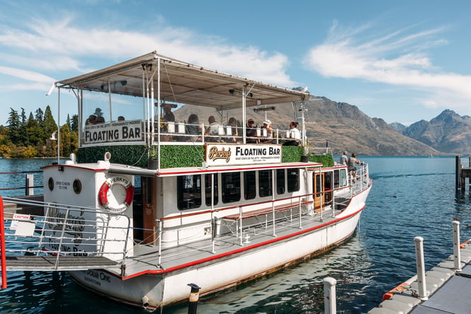 A large boat on a lake on a sunny day.