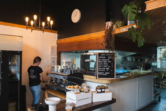 Barista at coffee machine at His & Hers.
