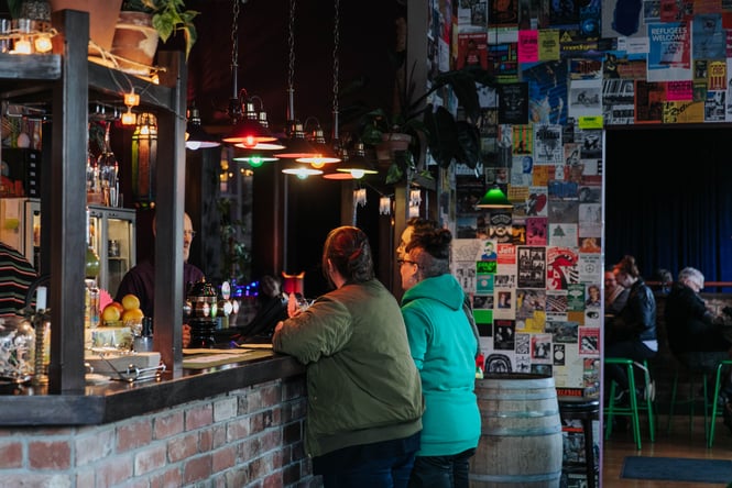 Patrons ordering at the bar at Woof!
