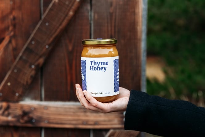 Customer holding a jar of Forage & Gold honey.