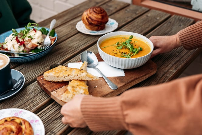 Platter of soup and toast being placed on the table at Muddy Creek Cafe.