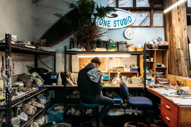 A man at work making pounamu jewellery.