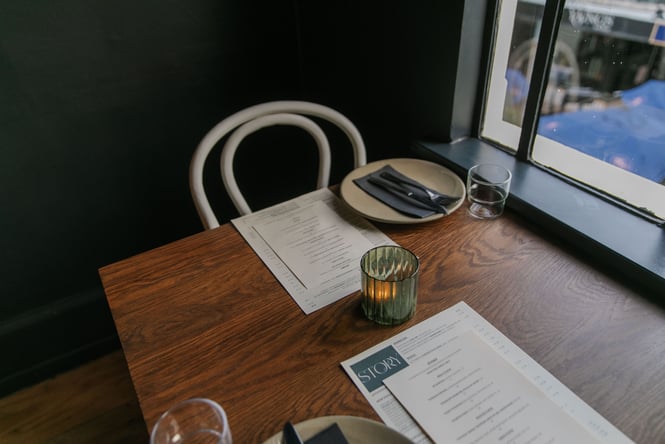 Close up of dining tables with menus at Story on New Regent Street in Christchurch