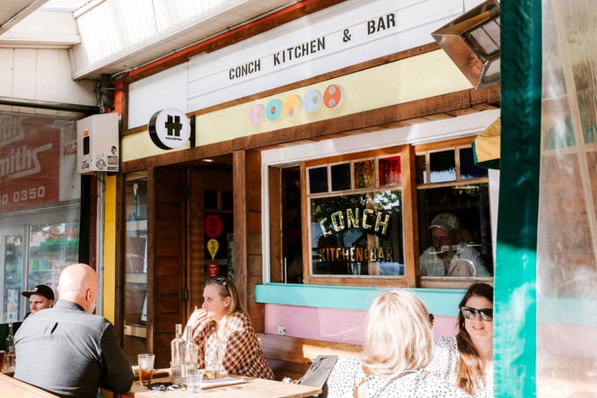 People dining outside Conch in Auckland.