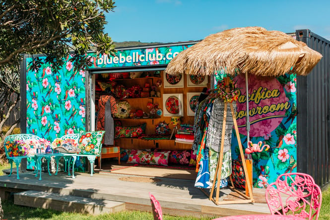 Umbrella and table set up outside of container at Blue Bell Club.