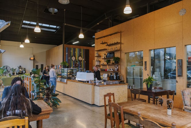 Interior of Prima roastery with warm corked walls and eclectic dining furniture