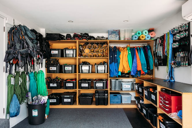 Equipment and other gear are stored on shelves and racks at Aspiring Guides.