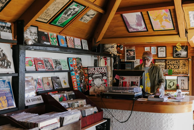 Man working behind the counter at Ride On Super Sound.