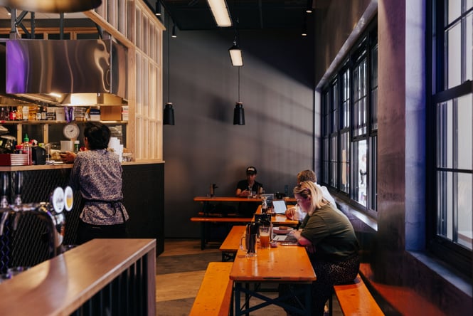 Customers on their own at long tables.