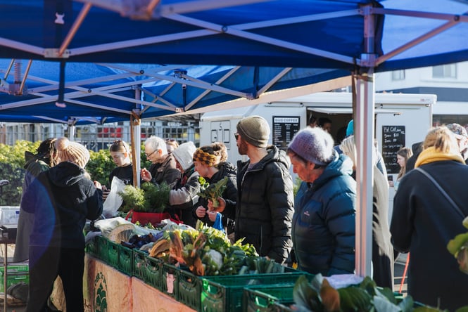 People lining up at an Otago Farmers Market stand.