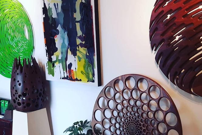 Colourful artworks covering the walls inside the gallery.