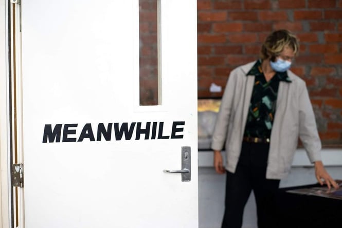 Photo Credit: Meanwhile Gallery Big white door with a black gallery logo on the front.