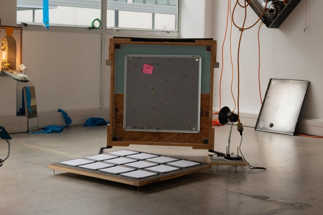 A Consumer’s Guide by Giulio Laura, Photo by Lindsey de Roos An Image of a boxed artwork in the middle of a natural lite room.