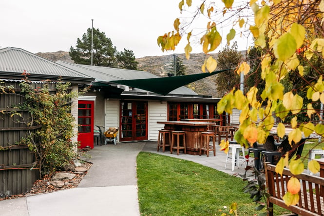 Outdoor tables and chairs in the garden at The Post Office Cafe and Bar.