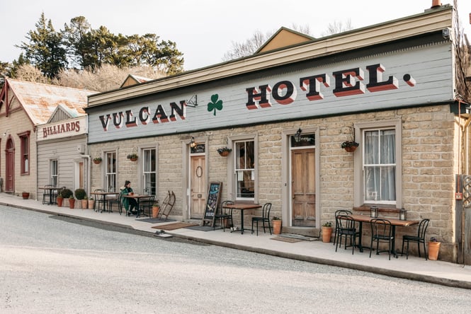 Tables and chairs placed on the footpath outside the pub at Vulcan Hotel.