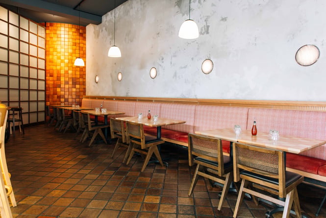 Long pink seating against a concrete wall.