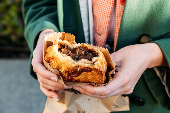 Hands holding a pie.