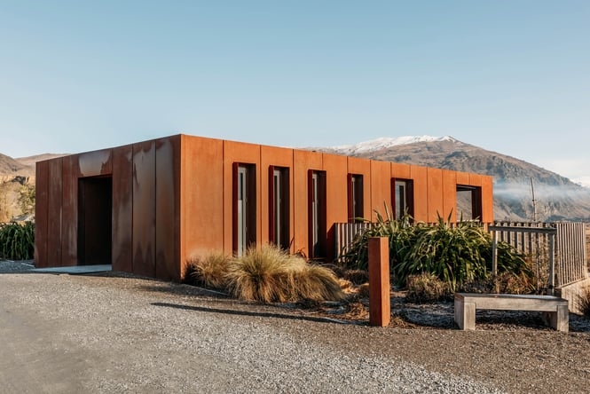 A rusty coloured exterior of a vineyard building.