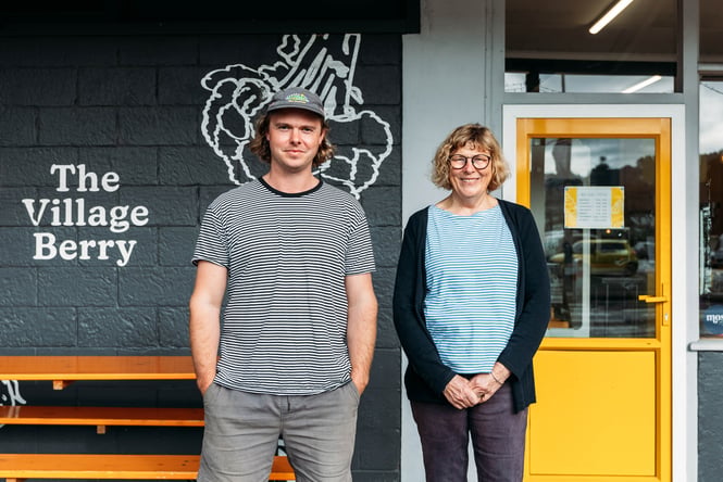 A man and woman smiling to camera.