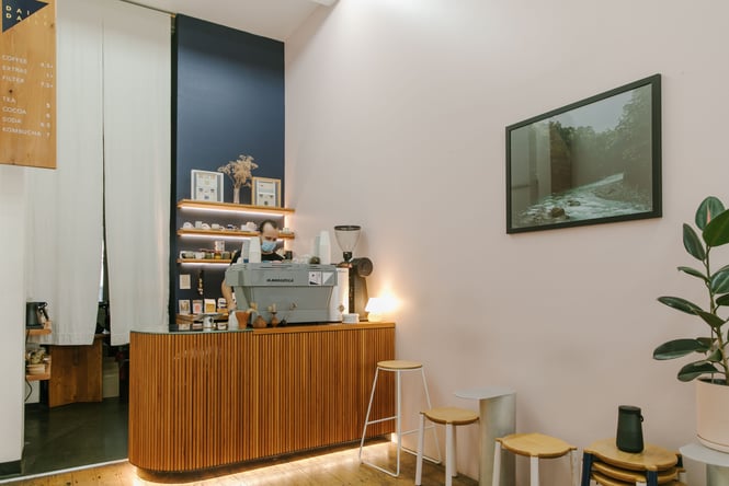A staff member working behind the counter inside the pretty Daily Daily cafe in Auckland.