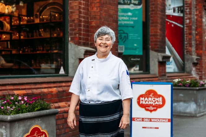 A chef smiling to camera.